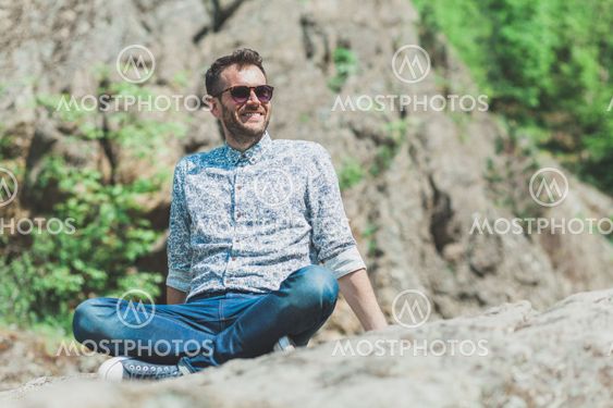 Beautiful young man enjoying in nature on the spring...