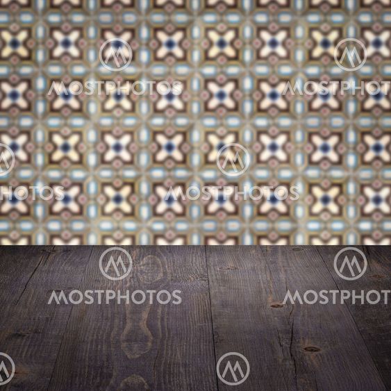 Wood table top and blur vintage ceramic tile pattern wall