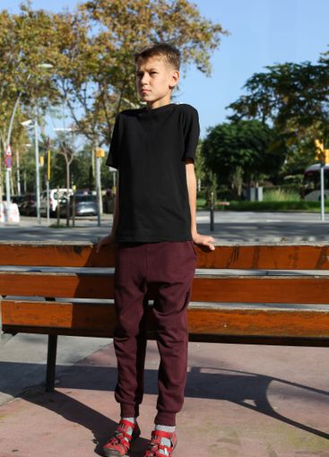 Handsome teenager standing with skateboard. Adolescent...