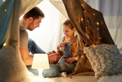 happy family playing with toy in kids tent at home