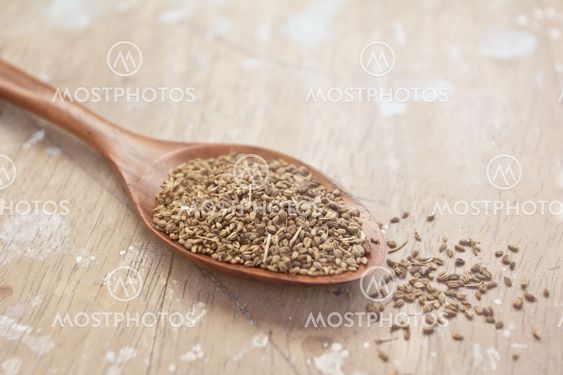 cumin seeds in wooden spoon