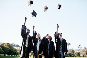 Students, graduation and celebration with hats in air...