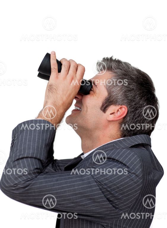 Visionary businessman looking through a pair of binoculars