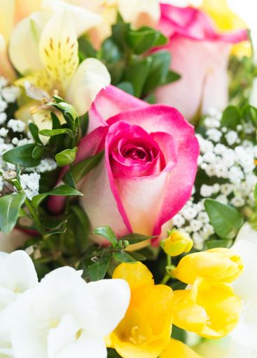 Beautiful bouquet featuring pink roses, white flowers,...