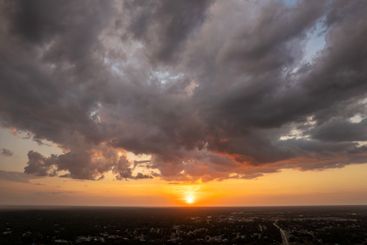 Bright colorful orange and yellow clouds over dark...