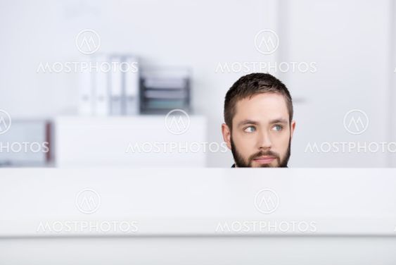Businessman Looking Away In Office Cubicle