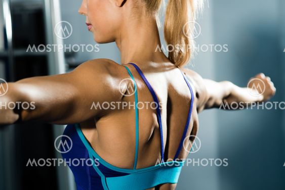female athlete straining back muscles and arms