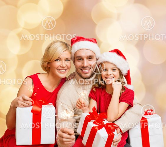happy family in santa helper hats with gift boxes