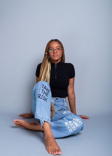 Beautiful brunette with braids in her hair, wearing...