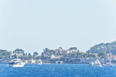 Daylight view to white yachts and boats cruising on water