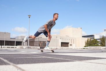 Man, ride and city with skateboard for speed, motion or...