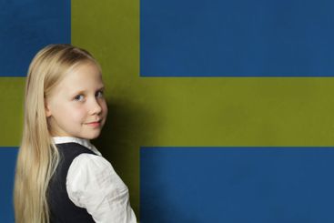 Cute young child girl on Swedish flag background....