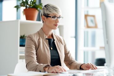 Computer, research and businesswoman in office with...