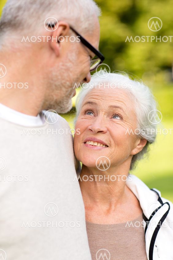 senior couple hugging in city park