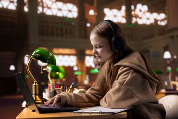 College student listening to study music to create the...