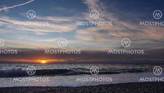 Evening seascape. Cirrus clouds in the sky.