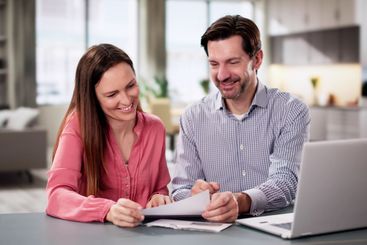 Couple Reading Good News at Home, Accountant