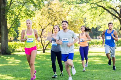 happy young sportsmen racing wit badge numbers