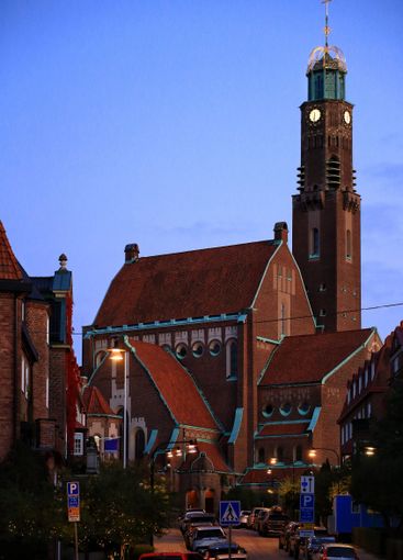 Engelbrektskyrkan church at dusk with red brick facade...