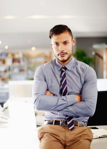 Man, arms crossed and professional in office, trading...