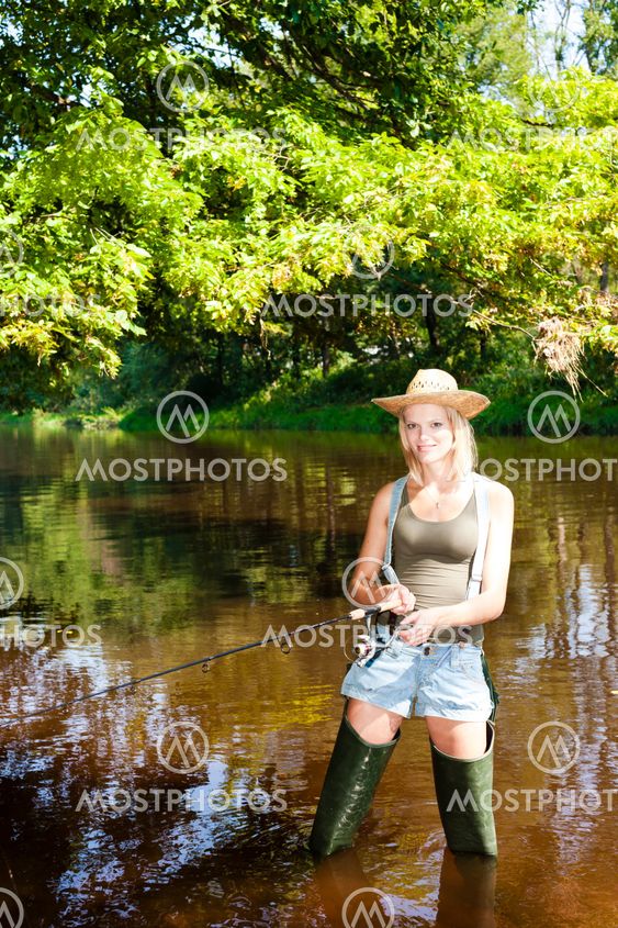 woman fishing in Jizera river, Czech Republic