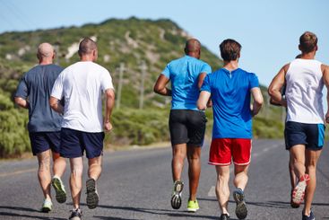 Group, exercise and men with running in road for...