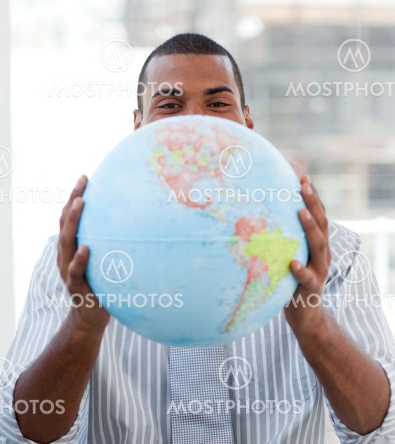 Fortunate businessman holding a terrestrial globe