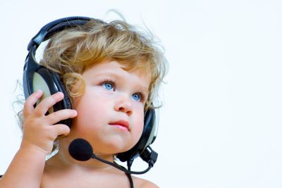 Portrait of young baby  listening music via phones.  