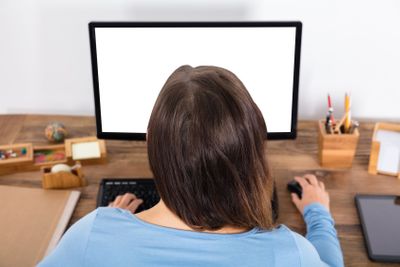 Woman Sitting In Front Of Desktop