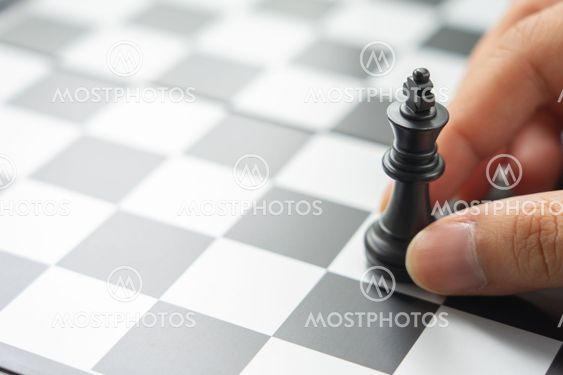 Businessman holding a King Chess is placed on a...