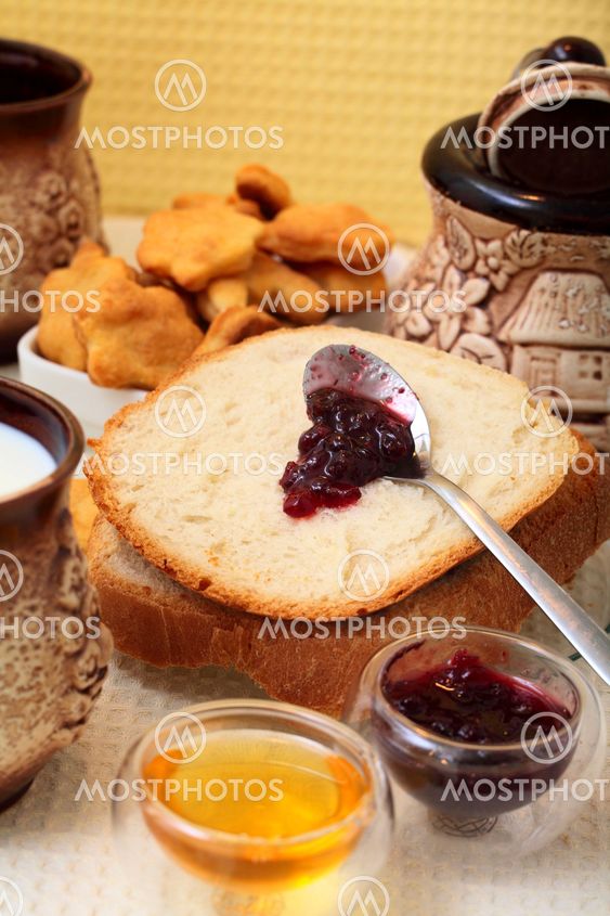 Homemade bread with redberries jam and honey