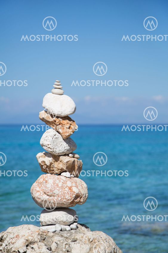 Blue ocean background with a pillar of stones for meditative or spiritual concepts