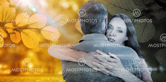 Composite image of casual couple hugging each other