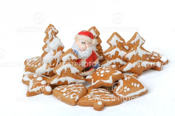 christmas gingerbreads and ceramic santa on white background
