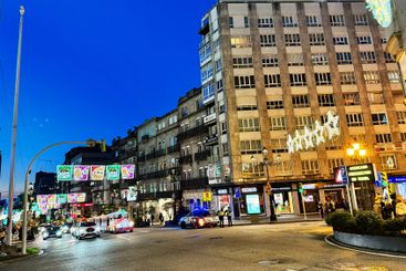 Illuminated city street at dusk in a vibrant urban...