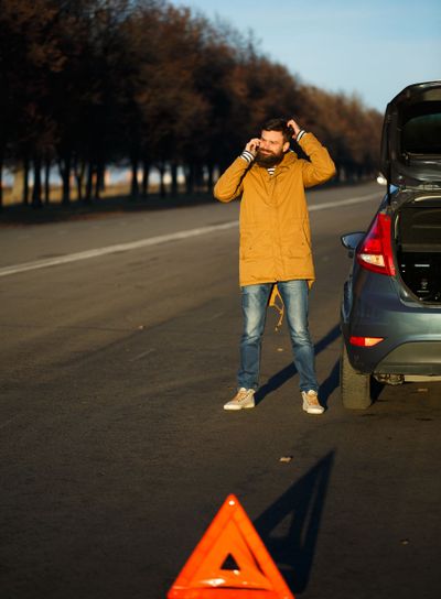 Driver man examining damaged automobile cars