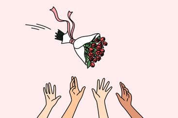 Maids of honor catch bride bouquet during wedding...