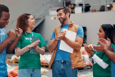 Applause, celebration and group of volunteers, happy and...