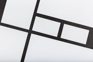 Unique layout of blank paper sheets arranged on a dark...