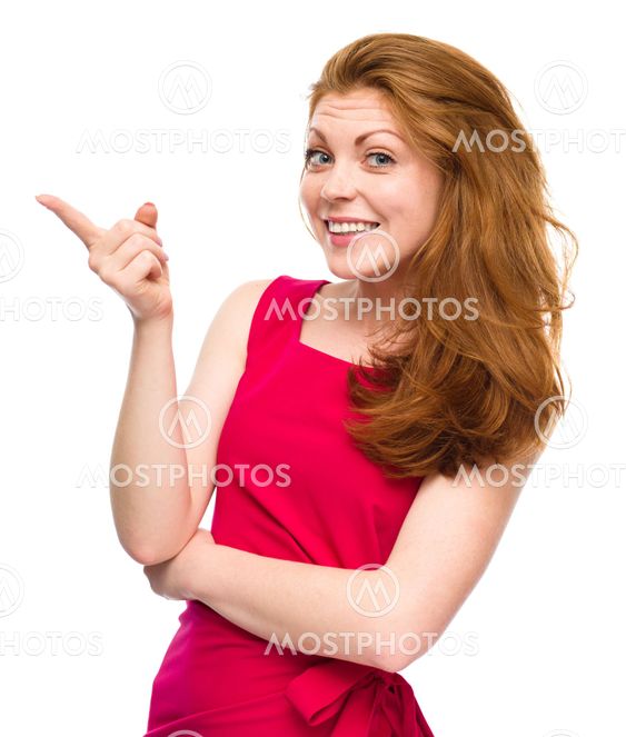 Portrait of a young woman pointing to the left