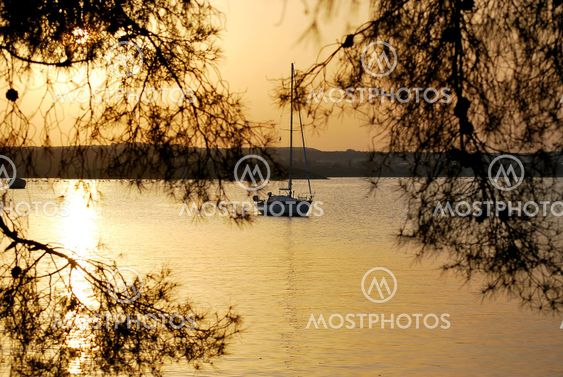Yacht in the rays of the setting sun