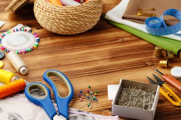 Crafting tools and materials arranged on a wooden table...