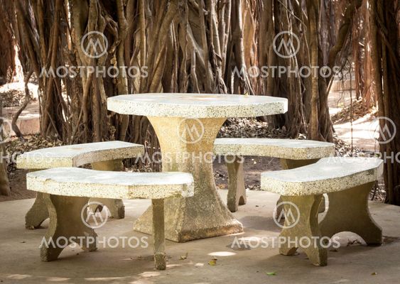 marble table in park with the tree root background,located in park