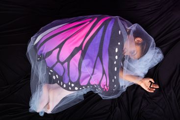 Teenage brunette girl in fetal position dressed in...