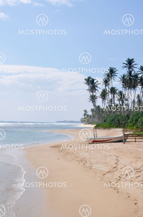 A boat at the beach on a bright sunny day