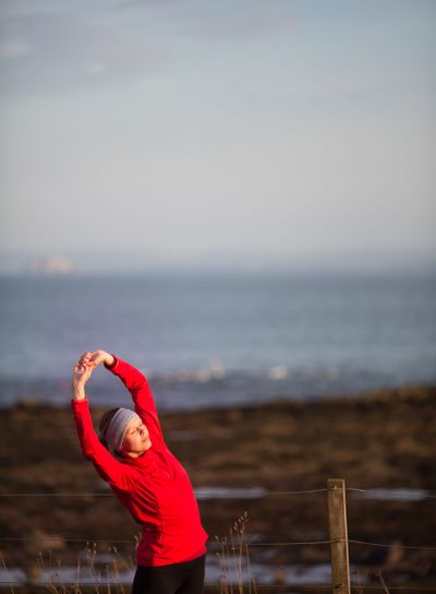 Young woman on her evening jog along the seacoast