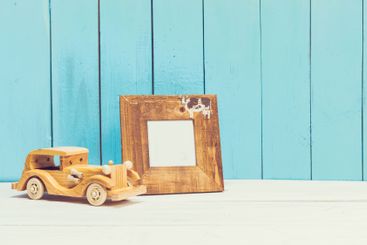Cozy pastel wooden home decor objects on blue background