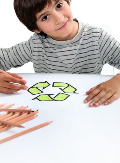 boy colouring recycling logo