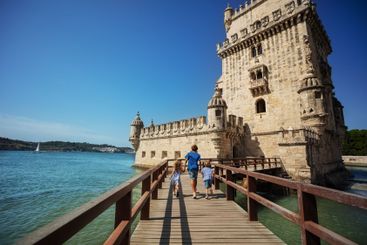 Group of kids travelers excited to visit famous tower Belem