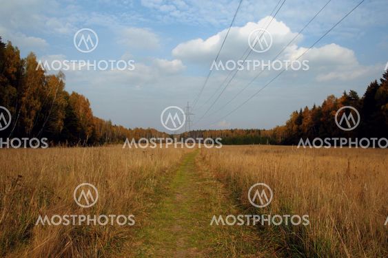 sun and clouds over rural road